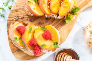 Charcuterie board with the best pâté, fresh summer fruit, cheese, and crackers